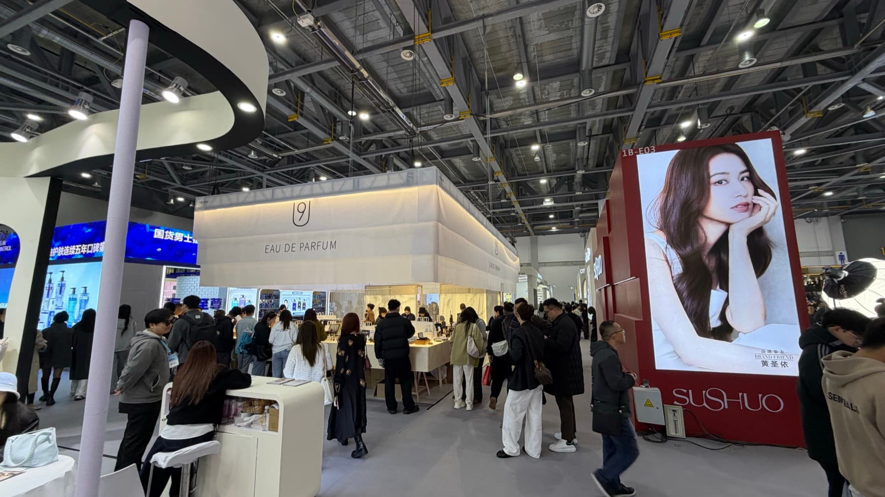 A busy CiE 2026 exhibition floor with perfume and beauty booths.