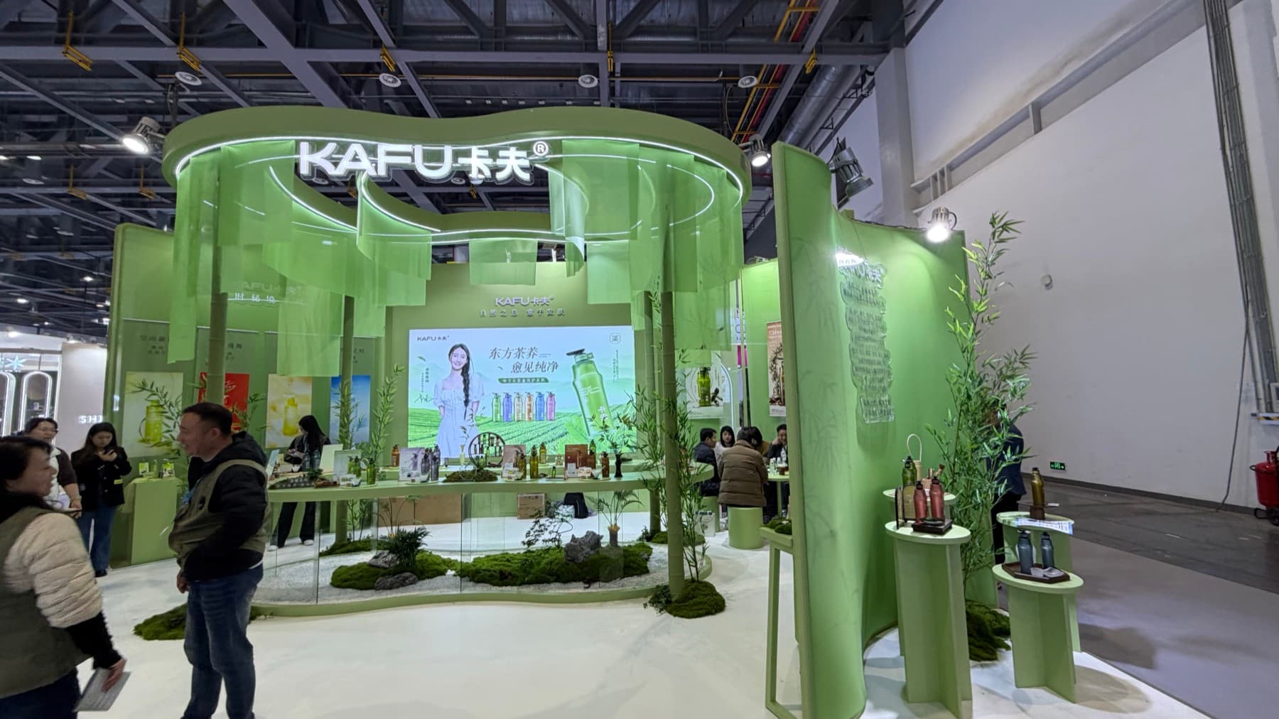 A green KAFU booth at CiE 2026 with bamboo-themed product displays.
