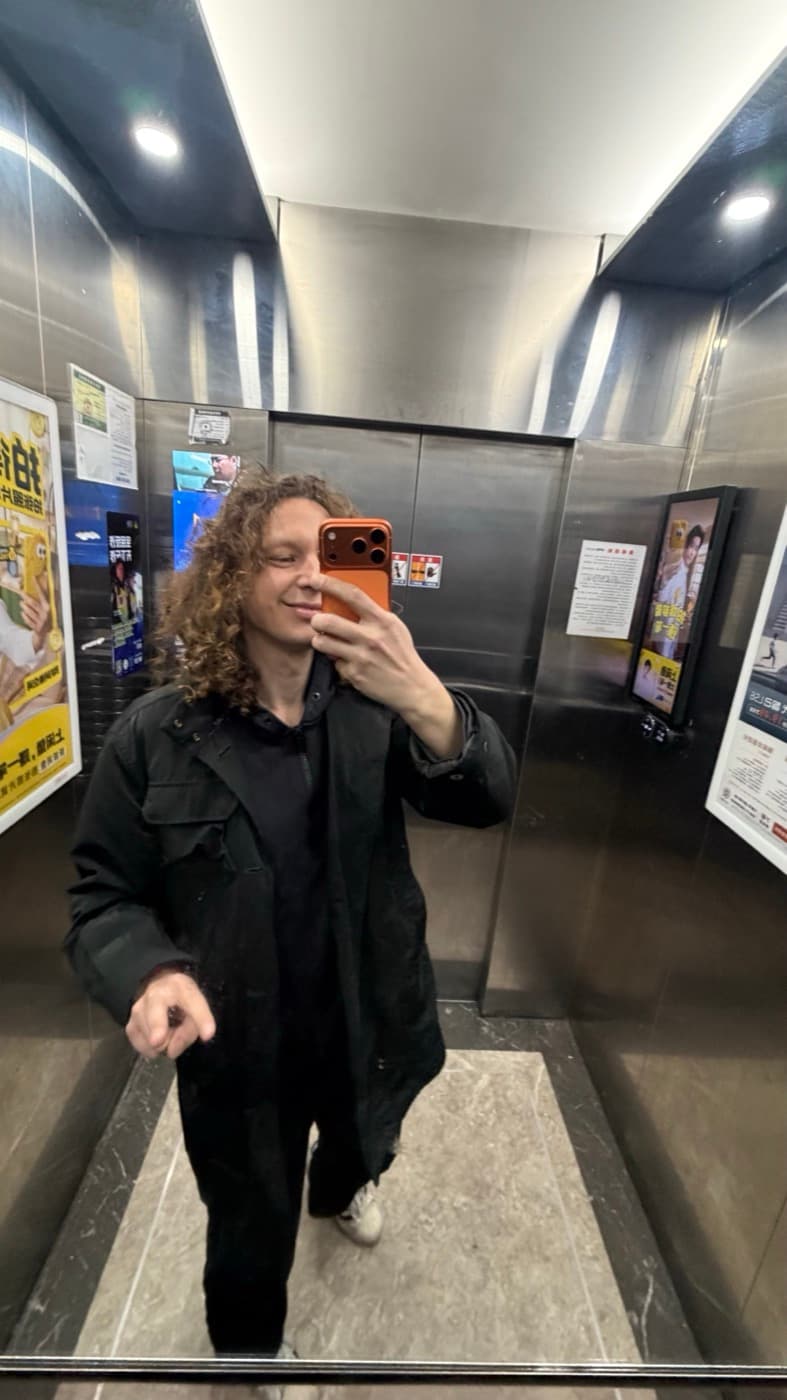 Kris Haamer taking a mirror selfie while traveling to the CiE 2026 event in Hangzhou.