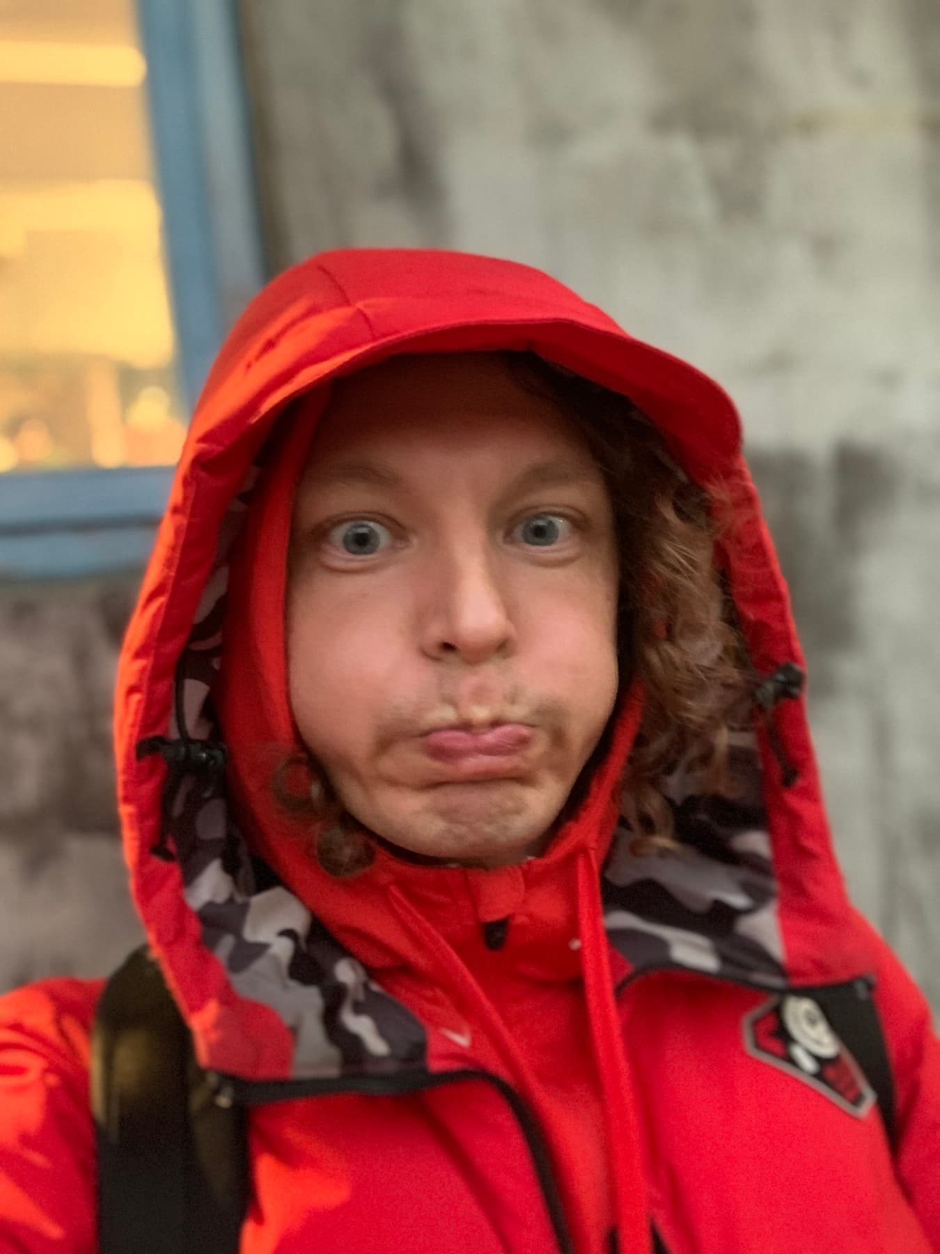 Kris Haamer wearing a red rain jacket in Taipei during WordCamp Asia 2024.